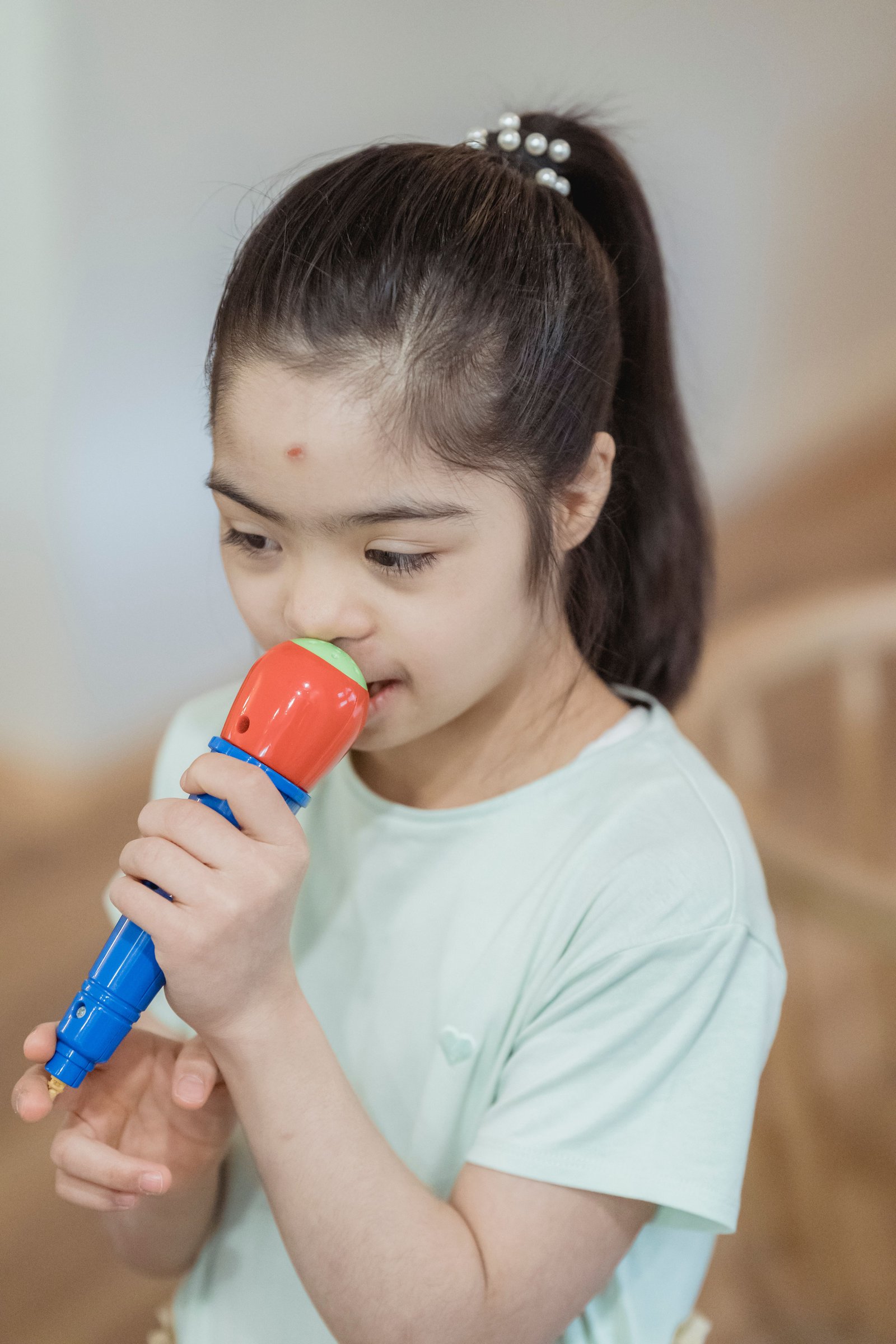 Specialist helping child with swallowing exercises